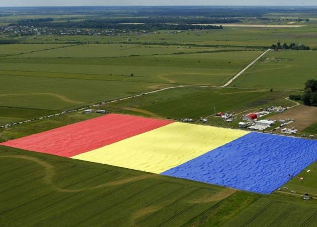 Villagers in Clinceni, Romania cover a field with what they claim is the world's biggest ever flag